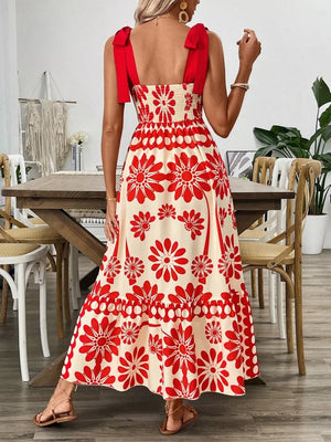 Red floral midi dress with tie shoulders and smocked bodice.