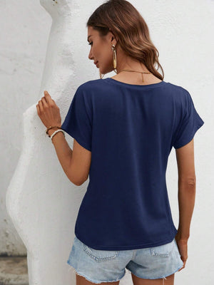 Dark blue t-shirt with short sleeves and a draped knot front detail.