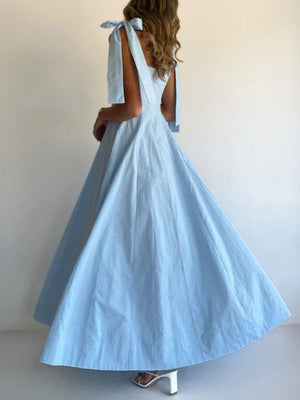 Light blue maxi dress with bow tie shoulder straps and a full skirt.