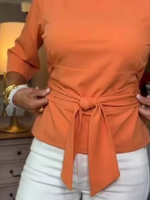 Orange 3/4 sleeve t-shirt with a chic tied waist detail.
