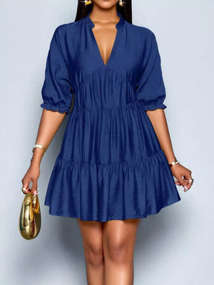 Navy blue tiered mini dress with notched V-neck and ruffled sleeves.