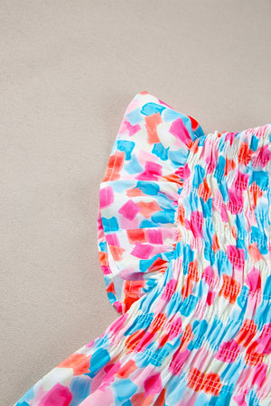 Smocked bodice blouse with brushstroke print in pink, blue, and coral.