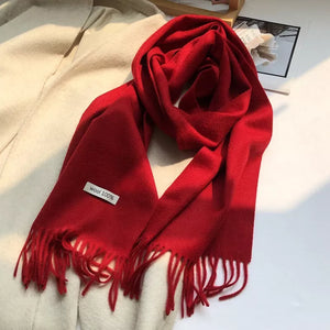 Luxurious Christmas Red wool knit scarf with fringes and a "wool 100%" tag.
