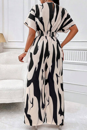 Abstract brushstroke wide-leg jumpsuit in black and taupe with short sleeves and elastic waist.