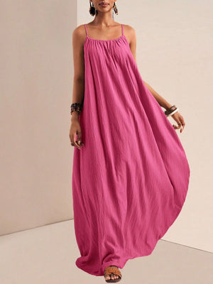 Fuchsia pink maxi swim dress with spaghetti straps and crinkled texture.