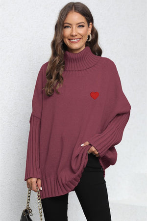 Burgundy knit turtleneck sweater with batwing sleeves and embroidered red heart detail.