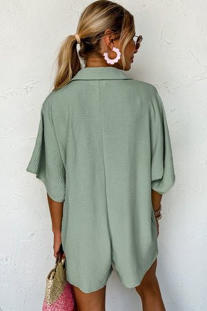 Sage oversized shirt romper with pockets and short sleeves.