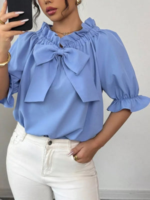 Sky blue ruffled bow sleeve blouse with elastic cuffs.