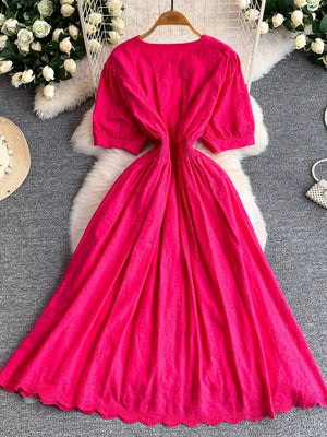 Pink lace-embellished A-line midi dress with puff sleeves and scalloped hem.