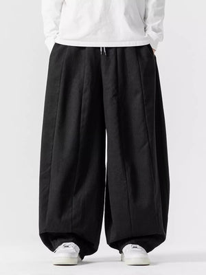 Black relaxed fit drawstring sweatpants with a baggy cut and wide legs.