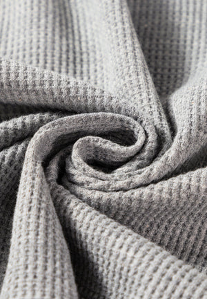 Light gray waffle knit cardigan detail showing texture and fabric.