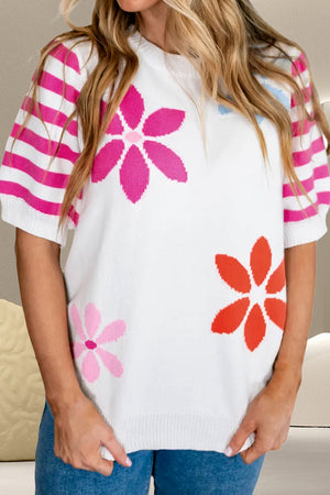 White knit top with floral appliques and pink striped puff sleeves.