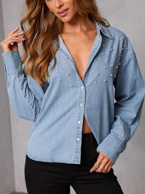 Light wash denim button-up shirt with pearl and rhinestone embellishments.