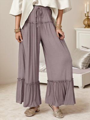 Mauve wide-leg pants with ruffle trim at the hem and drawstring waist.
