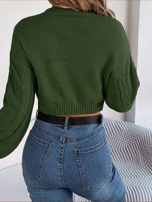 Army green acrylic cable knit cropped sweater with mock neck and long sleeves.