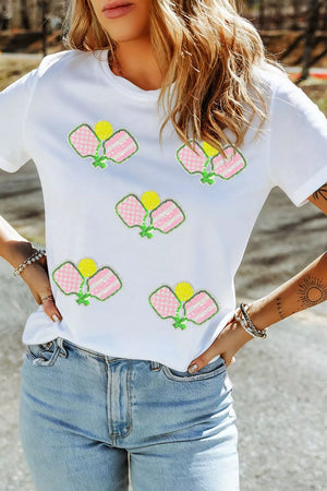 White cotton t-shirt with playful sequin pickleball applique detail.