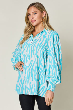 Blouse with zebra print, shirred cuffs, and balloon sleeves in Tiffany Blue.