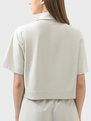 Beige cropped polo sportif top with short sleeves and a collar.