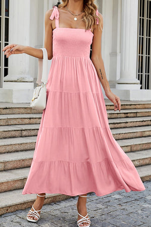Blush pink tiered ruffle maxi dress with smocked bodice and tie straps.