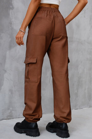 Brown utility cargo trousers with elasticated cuffs and multiple pockets.
