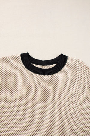 Beige knit top with black contrast trim neckline and cap sleeves.