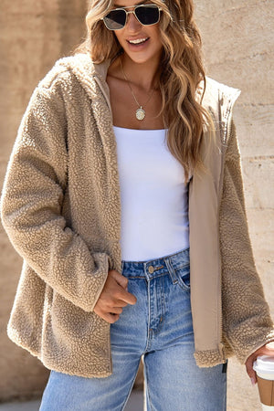 Sherpa lined hooded jacket in beige with contrast lining and zip closure.