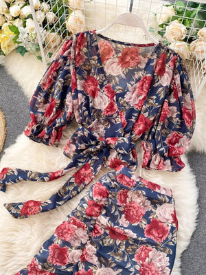 Chic floral two-piece crop set in dark blue with v-neck, puff sleeves, and tie waist.