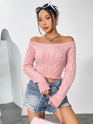 Blush pink cable knit cropped off-the-shoulder sweater with long sleeves.