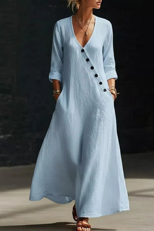 Light blue maxi dress with V-neck, button detail, and pockets.