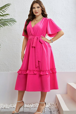 Hot pink wrap-front midi dress with flutter sleeves, belted waist, and tiered ruffled hem.