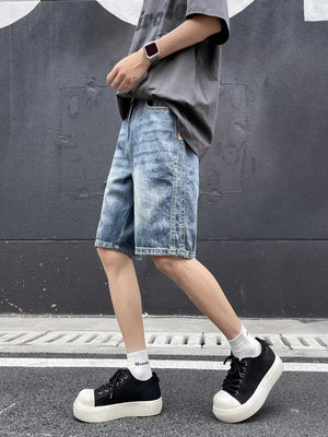 Relaxed fit blue denim shorts with a faded wash and whiskering detail.