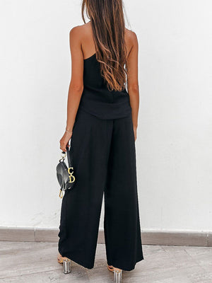 Black pleated palazzo pants and cami set with wide legs and a chic silhouette.