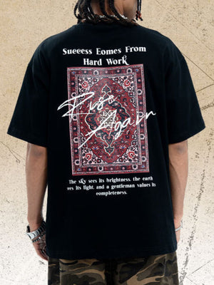 Black cotton crew neck t-shirt with oversized fit and graphic rug print with text.