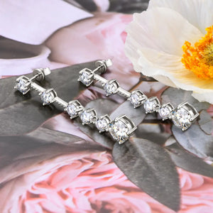 Silver cascading drop earrings with multiple clear cubic zirconia stones.