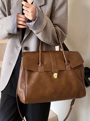 Dark brown PU leather tote bag with buckle detail and gold hardware.
