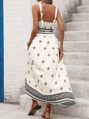Geometric print midi dress with wide straps, smocked waist, and a-line skirt.