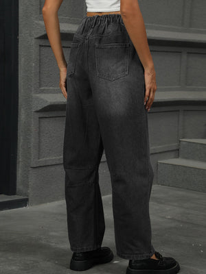 Relaxed fit dark wash denim trousers with elastic waistband and patchwork detail.