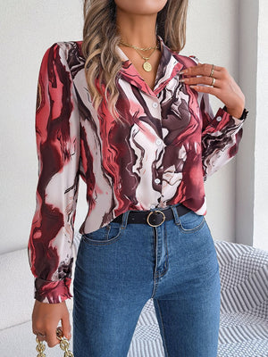 Women's abstract swirl print silk blouse in red and white with button front and long sleeves.