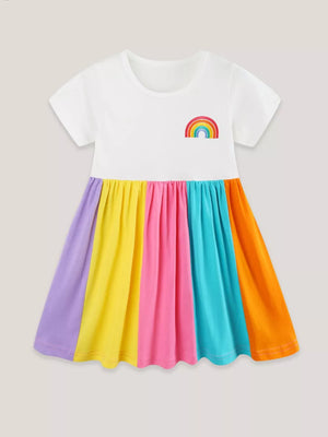 White toddler dress with rainbow embroidery and a colorful striped skirt.