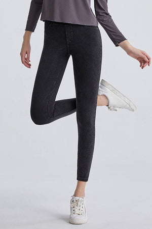 Dark gray denim leggings with faux pockets and a high waist.