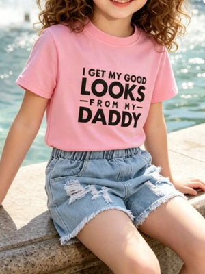 Pink cotton tee with "I GET MY GOOD LOOKS FROM MY DADDY" graphic and distressed denim shorts.