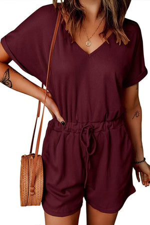 Burgundy ribbed V-neck romper with adjustable drawstring waist and cuffed short sleeves.