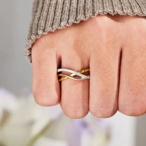Intertwined trio diamond ring in gold-plated metal with pave diamond accents.