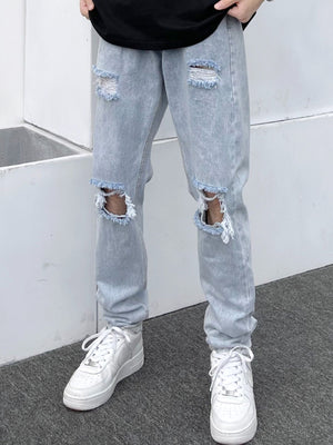 Light blue distressed slim fit men's jeans with ripped knees and frayed hems.