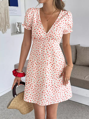 Floral V-neck puff sleeve mini dress with a red floral print on white fabric.