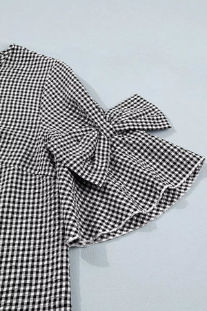 Gingham bow tie ruffled sleeve shirt in black and white polyester.