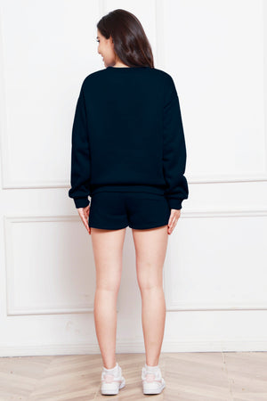 Dark blue crewneck sweatshirt and pocket shorts loungewear set worn by a woman.