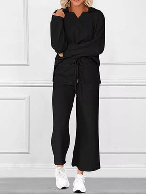 Black V-neck textured two-piece lounge set with diagonal pattern and drawstring pants.