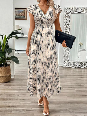 Midi dress with abstract print, V-neck, cap sleeves, and a-line skirt.