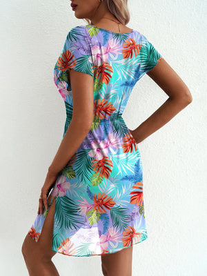 Vibrant leaf print mini dress in sky blue with short sleeves and a high slit.